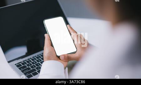 Design creative work space, Business Woman using smartphone, Social media advertisement, Cell phone white screen mockup, Human hand holding mobile pho Stock Photo