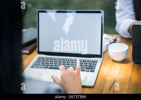 Young business woman sitting at table using laptop in coffee shop cafe. Blogging Freelancers working. Woman using laptop. Stock Photo