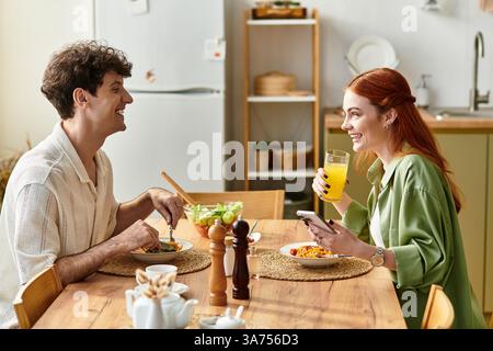 Loving couple enjoys a delightful meal at home, sharing stories and laughter over food. Stock Photo