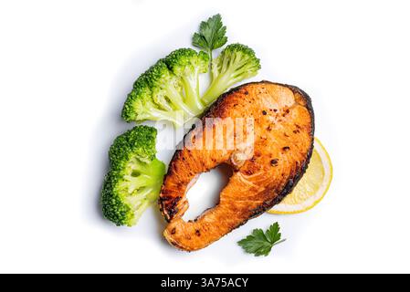 Roasted Salmon fish steak with steamed broccoli vegetables and lemon slice isolated on white background, top view. Healthy balanced food concept, keto Stock Photo