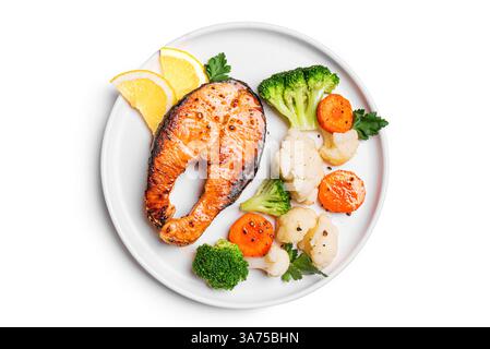 Grilled Salmon Steak and Steamed Vegetables on plate isolated on white background, top view. Healthy food, keto diet. Stock Photo