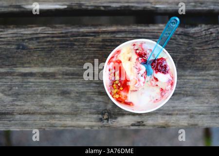 ice cream in paper cup view from ferhu on wooden background. disposable paper cup. ecology saving nature, waste recycling Stock Photo