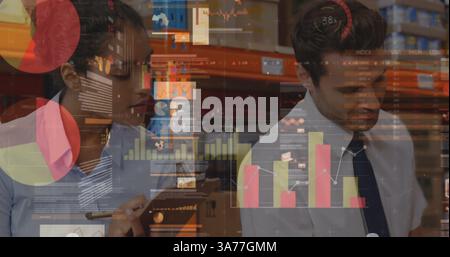 Statistical data processing against diverse male and female supervisor checking stock at warehouse Stock Photo