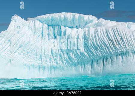 Floating Iceberg with Compressed Ripple Structured Ice in Antarctica. Stock Photo