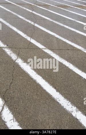 White painted stripes on the asphalt surface of a road. Stock Photo