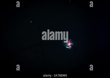 Mysterious UFO Sighting in the Night Sky – Unexplained Flying Object with Red and Green Lights - eerie blurred abstract  U.F.O. Concept Stock Photo