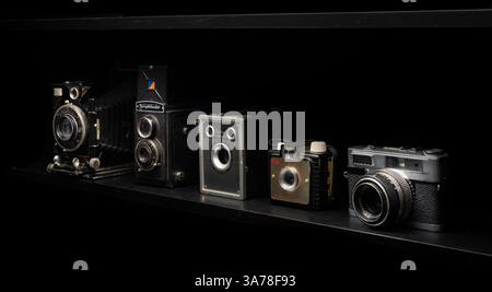 Old, vintage cameras on shelf. Stock Photo