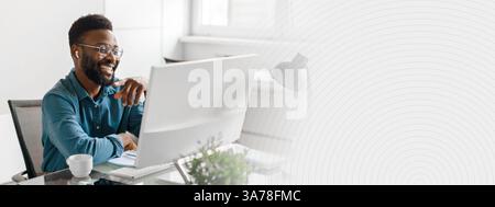 Young African American businessman working on his computer in a modern office Stock Photo