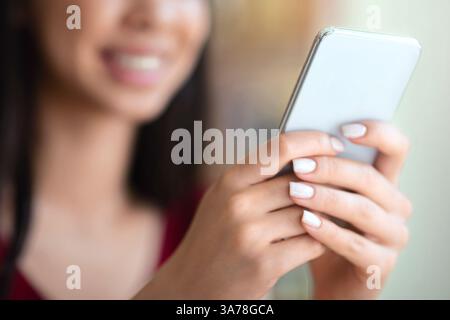Closeup Image Of Unrecognizable Woman Using Modern Smartphone, Texting Or Browsing Internet Stock Photo