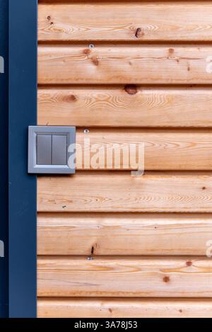modern gray double light switch on the wall of wooden house Stock Photo