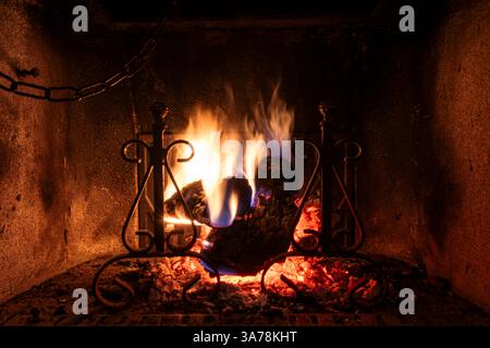Flames into an old fireplace in Europe. Stock Photo