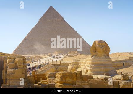 Giza, Egypt - 11 03 2023, a panoramic view of Great Pyramids of Giza and Sphinx on foreground. At daytime, with many of tourist on background, Giza, E Stock Photo