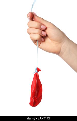 Woman holding popped red balloon on white background, closeup Stock Photo