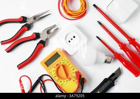 Different electrical tools on light background, flat lay Stock Photo