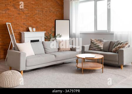 Interior of living room with sofas, fireplace and mirrors Stock Photo
