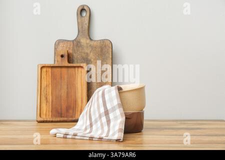 Checkered napkin on pots on table against white background. Closeup Stock Photo