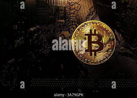 Bitcoin golden coins on a printed circuit board. Bitcoin concept, Blockchain technology, Cryptocurrency, virtual money. Stock Photo