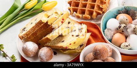 Variation of Easter dishes. Stylish Easter eggs in plate with sweets. Top view. Stock Photo
