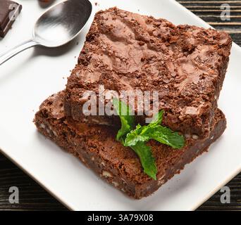 Dark bitter, milk and white chocolate,  cocoa butter, cacao powder and beans on a grey background. Top view. Stock Photo