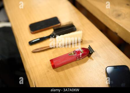 Hairdressing tools laying on wooden table in salon Stock Photo