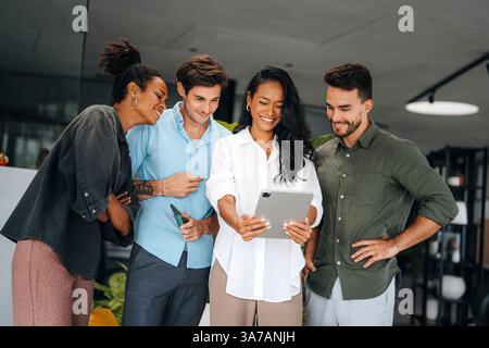 A diverse, talented team collaborates effectively in a bright office space during a business meeting Stock Photo
