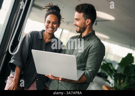 Group of young multi-ethnic startup business team collaborating on project in modern office Stock Photo