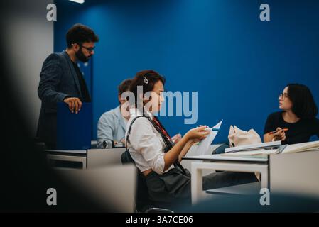 Students engaged in lively discussion during classroom session Stock Photo