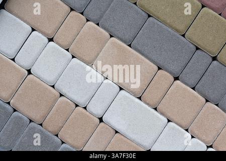 Paving slabs for road paving by mosaic on shop window. Construction Stock Photo