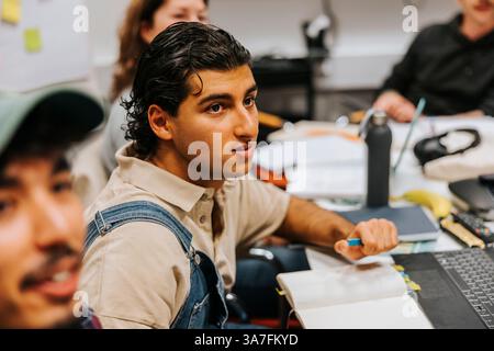 High angle view of young male student studying in classroom at university Stock Photo