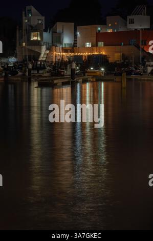 A nighttime picture of the lights of Watchet reflecting across the inner harbour at Watchet Marina, Watchet, Somerset, England, UK. Stock Photo