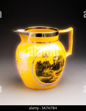 A vibrant yellow pitcher with intricate designs, featuring a scenic landscape and ornate detailing around the body, complemented by a sleek metallic rim and handle., Classic art with a modern twist reimagined by Artotop, Jug, c. 1820, England, Staffordshire, Staffordshire, Lead-glazed earthenware with yellow ground, black enamel and silver lustre decoration, H. 20.3 cm (8 in.) Stock Photo