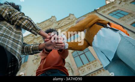 Happy laugh multiracial friends three students multiethnic girls Caucasian female women African American male guy man in city in college university Stock Photo