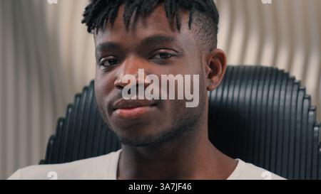 Portrait face futuristic confident serious gamer programmer calm African American man guy male in futurism modern white room studio looking at camera Stock Photo