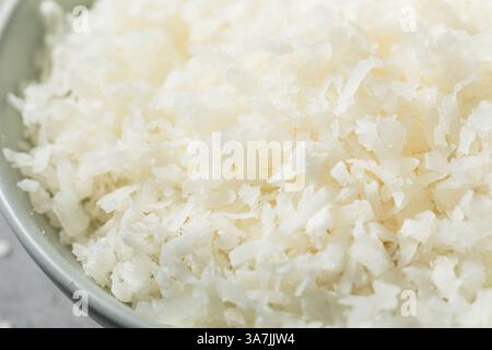 Sweetened Organic Coconut Shreds with Sugar in a Bowl Stock Photo