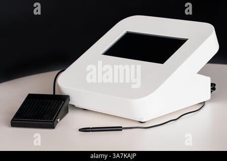 Modern Digital Signature Capture Device with Touch Screen, Stylus Pen, and Control Pedal on White Table. Stock Photo