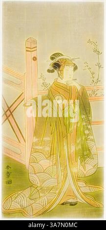 A gracefully dressed figure in a traditional kimono stands against a ...