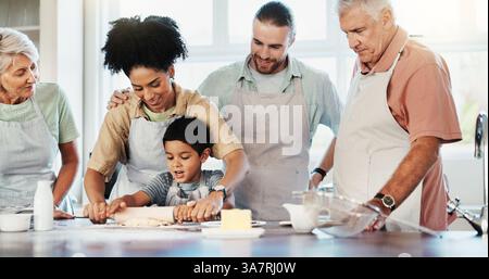 Home, big family and baking in kitchen, boy and ingredients with recipe, bonding together and help. Grandparents, mother or father with son, child Stock Photo