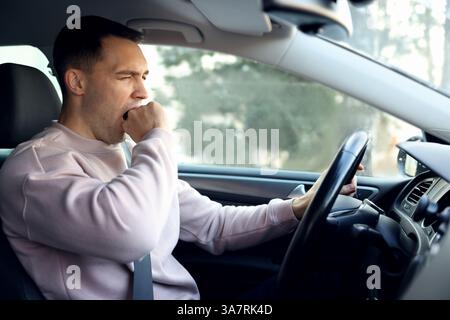 Sleepy driver yawning in his modern car Stock Photo - Alamy