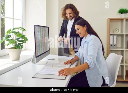 Business people at work in office on workplace. Company employees analyzing company finance data. Stock Photo