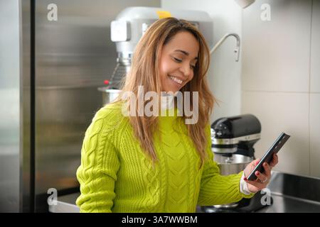 latina woman looking at her cell phone screen Stock Photo