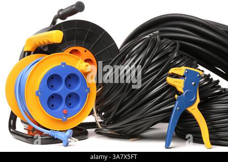 Wire stripper, rolled cables and extension cable reel on white background Stock Photo