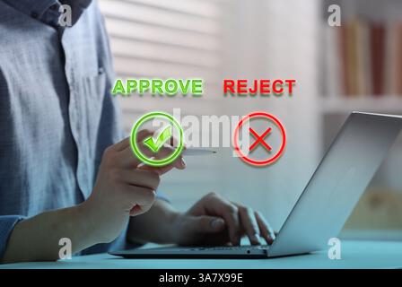Approve or reject. Man using laptop at table in room, closeup Stock Photo