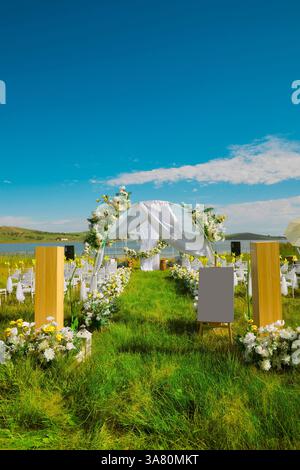 Lakefront Wedding Venue with White Tent and Floral Decorations Stock Photo