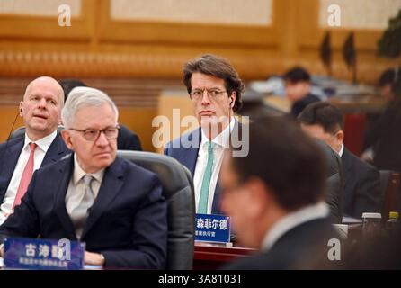 Peking, China. 28th Mar, 2025. Klaus Rosenfeld (M), CEO of the Schaeffler Group, sits in the Great Hall of the People. China's head of state and party leader Xi promoted China as a safe investment location in front of international CEOs. Credit: Johannes Neudecker/dpa/Alamy Live News Stock Photo