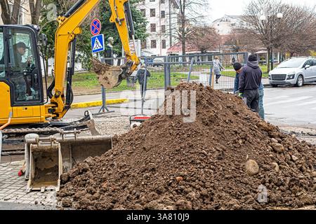 road construction and repair in the city on a rainy day Stock Photo
