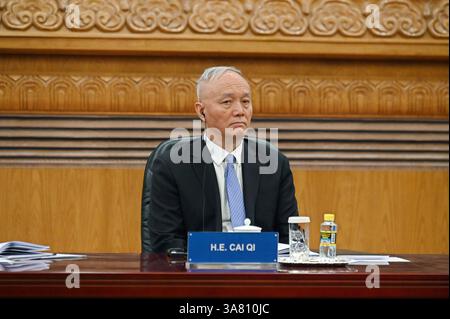Peking, China. 28th Mar, 2025. Cai Qi, Secretary of the Secretariat of the Central Committee of the Communist Party of China, sits in the Great Hall of the People. China's head of state and party leader Xi promoted China as a safe investment location in front of international CEOs. Credit: Johannes Neudecker/dpa/Alamy Live News Stock Photo