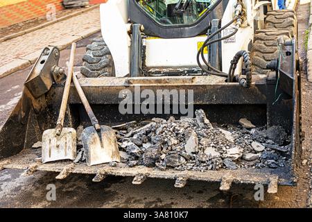 road construction and repair in the city on a rainy day Stock Photo