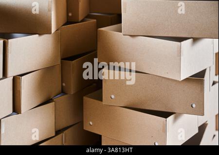 Creative cardboard box blanks stacked together in a manufacturing facility for efficient production and design possibilities Stock Photo