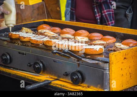 Pulled pork burgers with mayonnaise being prepared at Brick Lane market in London Stock Photo