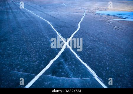 Ice Cracks and Patterns on Frozen Lake Stock Photo